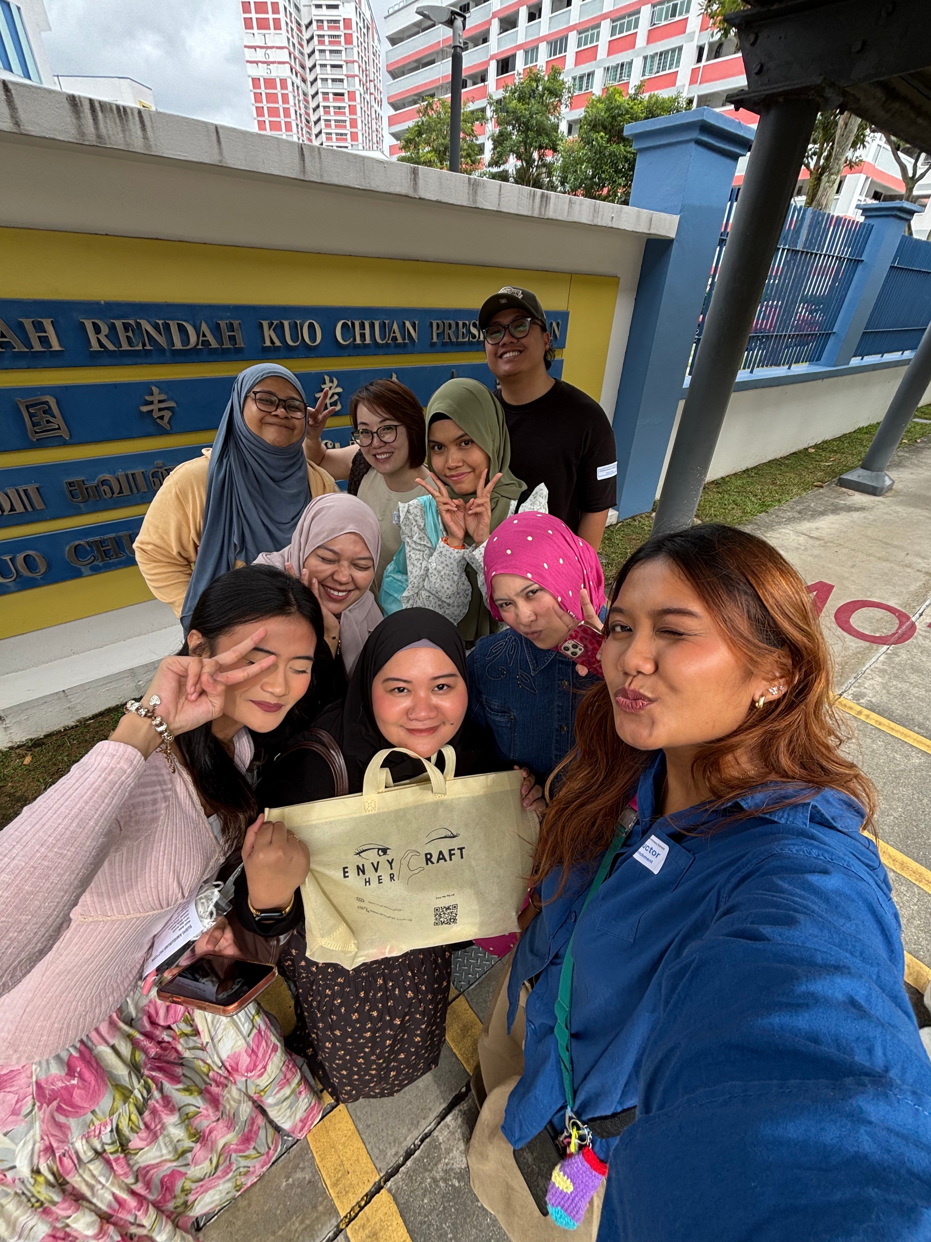 a group of teachers in front of a school massive basic crochet workshop for 98 members of the Girls’ Guides CCA